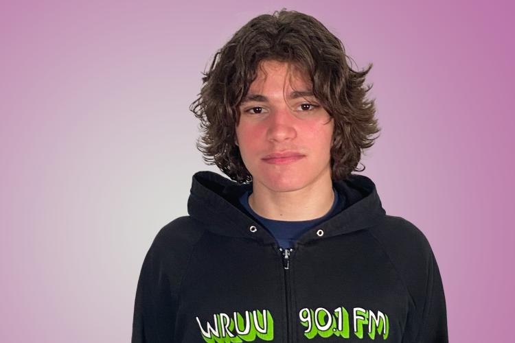 a medium shot of Nico Listi, wearing a black hoodie with WRUV printed on it