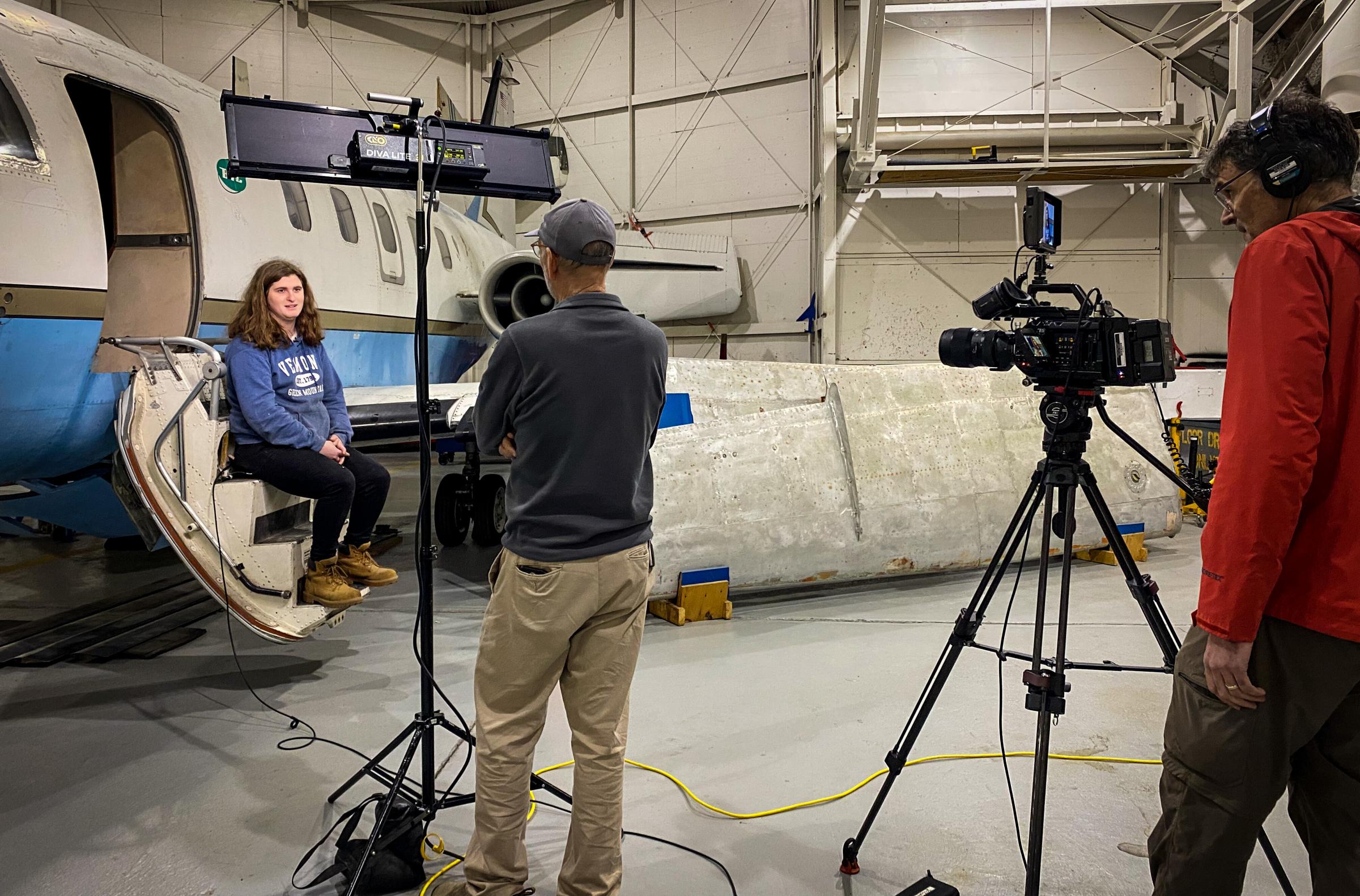 A student is interviewed in front of an airplane as part of the BTC Aeronautics Program